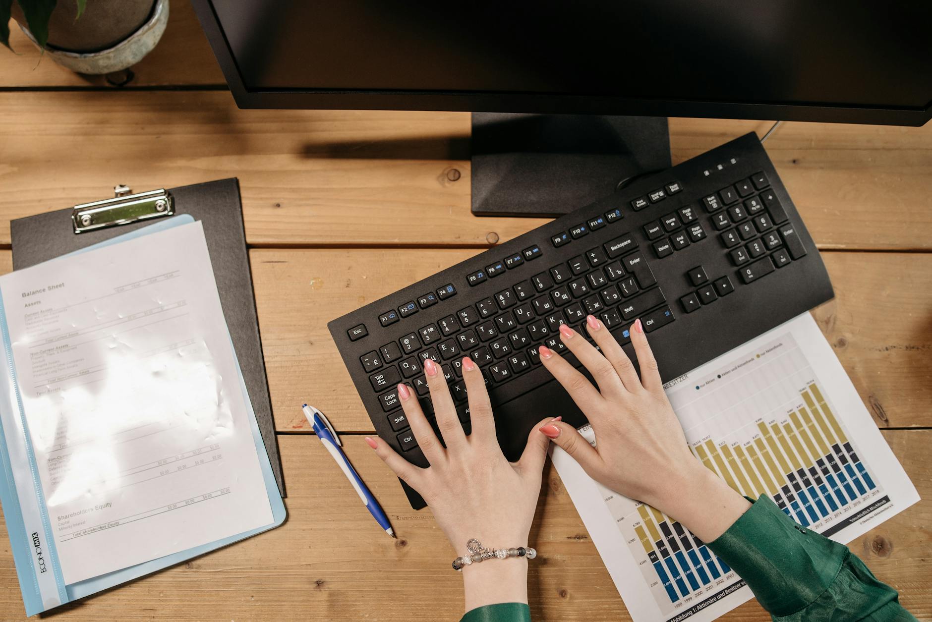 Person working on a computer with a spreadsheet open